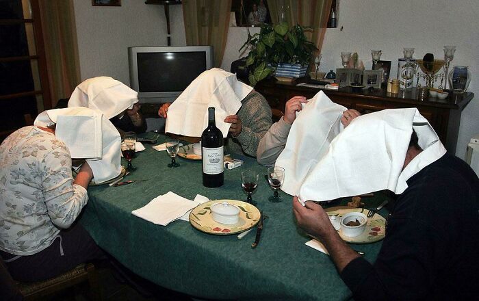 People Eating The Traditional French Meal Of Ortolan Bunting. The White Cloth Over Their Head Is To Hide Their Sin Of Eating The This Particular Meal From God