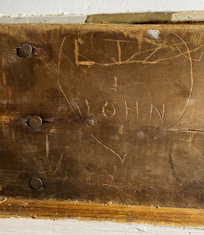Bottle Of Vodka Tucked In The Insulation And Names Of Previous Owners Carved In Beam