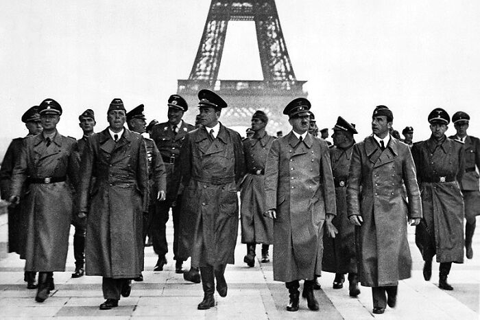Adolf Hitler And His Entourage Walk Near The Eiffel Tower In Paris On June 23, 1940, Following The Occupation Of France By The Nazis