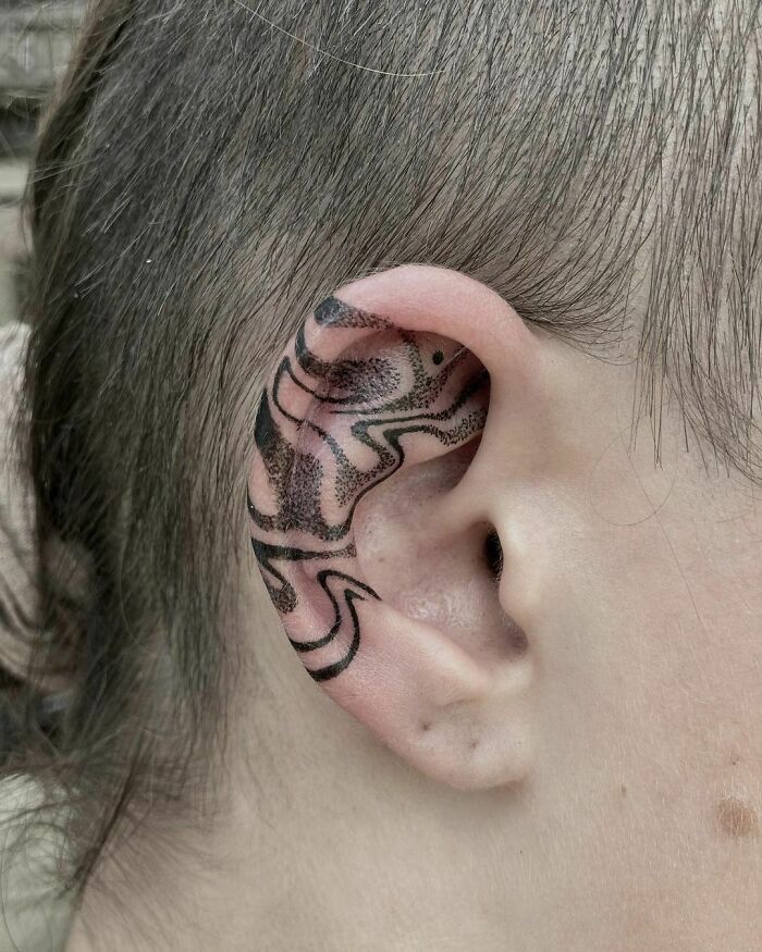 ear tattoo of a wave