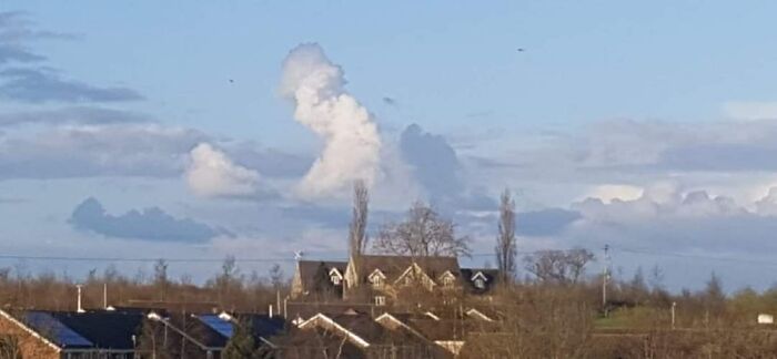 A Lady With A Hat At Her Desk