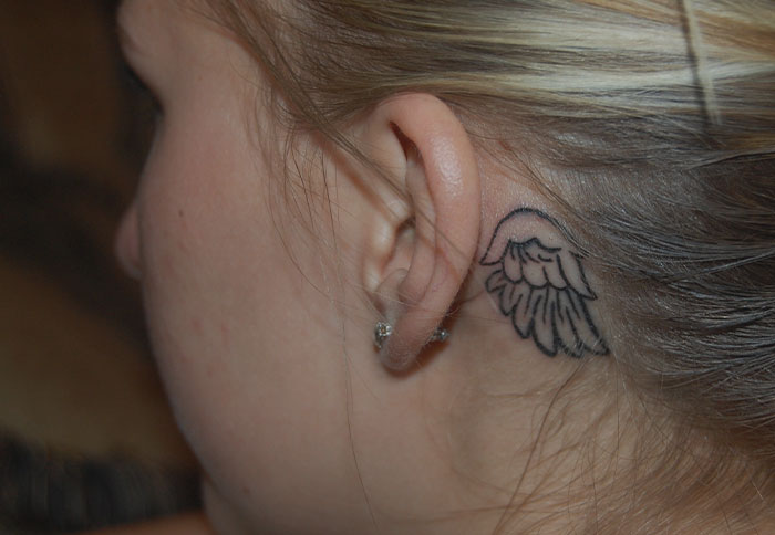 ear tattoo of a single wing