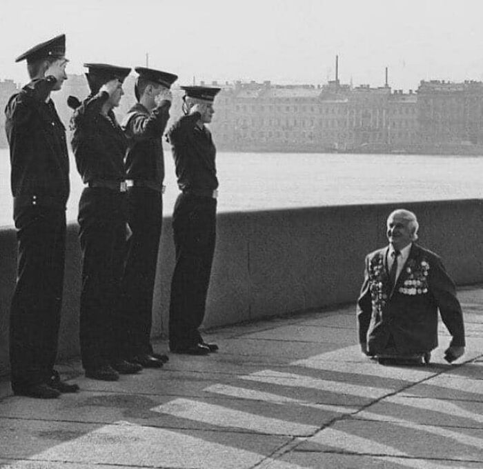 Anatoly Golombievsky, A Soviet Veteran Who Lost Both His Legs During The Battle For Novorossiysk, During World War II, Takes The Salute Of 4 Cadets At The Nakhimov Navy School On V-Day In Leningrad, 1989