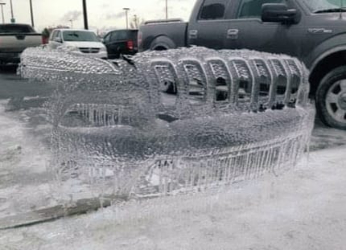 A Front Grill Of A Jeep Cast In Ice
