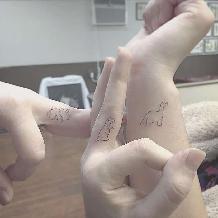 Minimalistic dino family tattoo