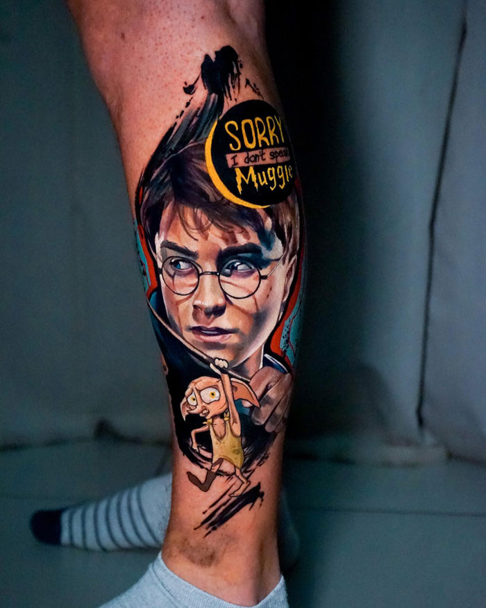 Harry Potter tattoo featuring his face and Dobby with "Sorry I don't speak Muggle" text on a leg.