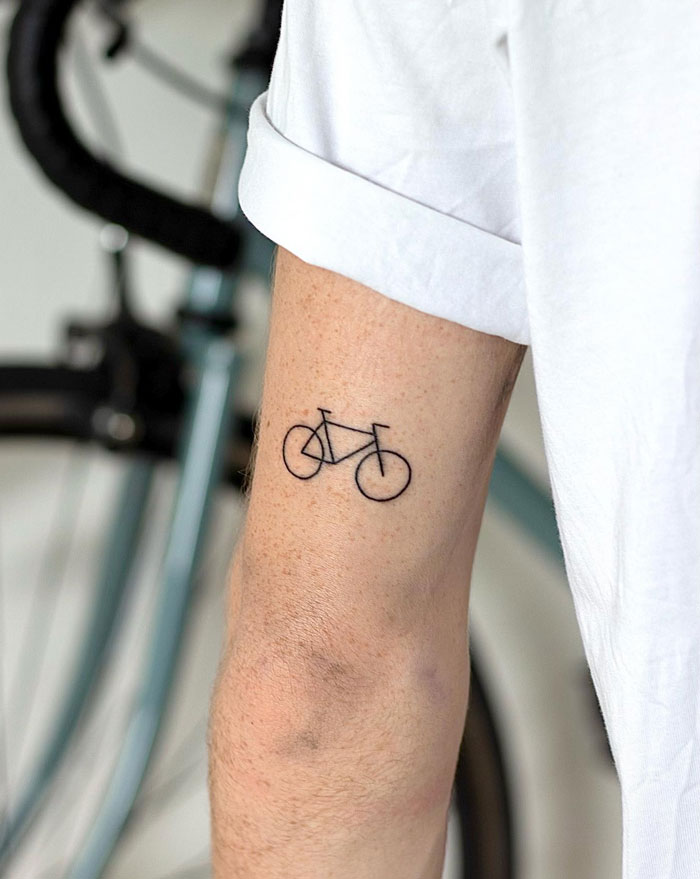 minimalistic tattoo of a bicycle 