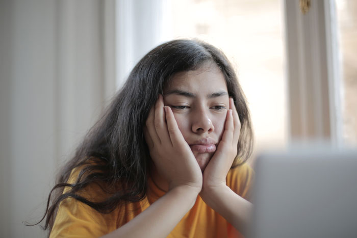 Woman tired watching laptop screen