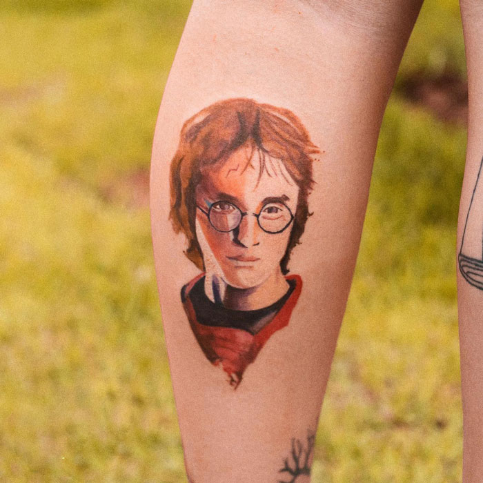 Harry Potter tattoo on forearm, featuring glasses and lightning scar, for fans of the Wizarding World.