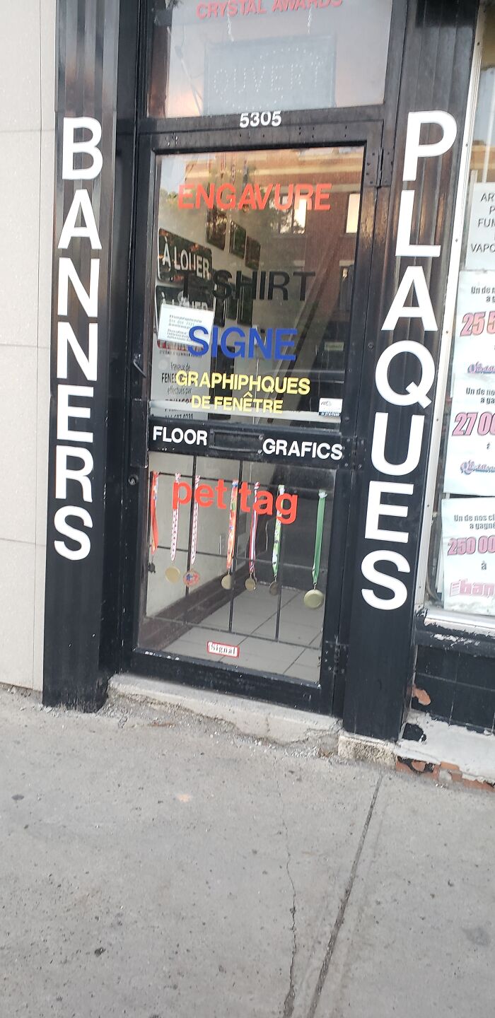 Should Be "Gravures" And "Graphiques". This Is An Advertisement For Their Signage Business. Maybe Start By Getting 1 Language Right?