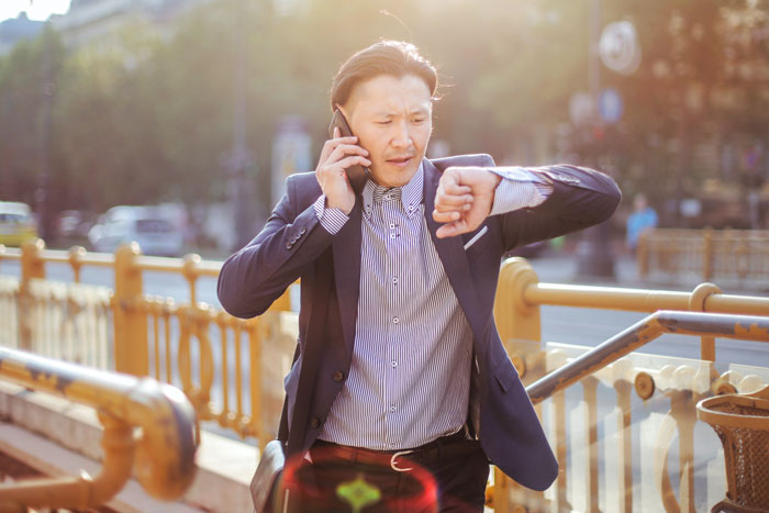 a man looks at the clock on his wrist