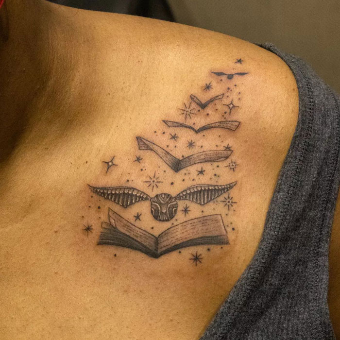 Harry Potter tattoo featuring a flying book, Golden Snitch, and stars on shoulder, ideal for any Potterhead.