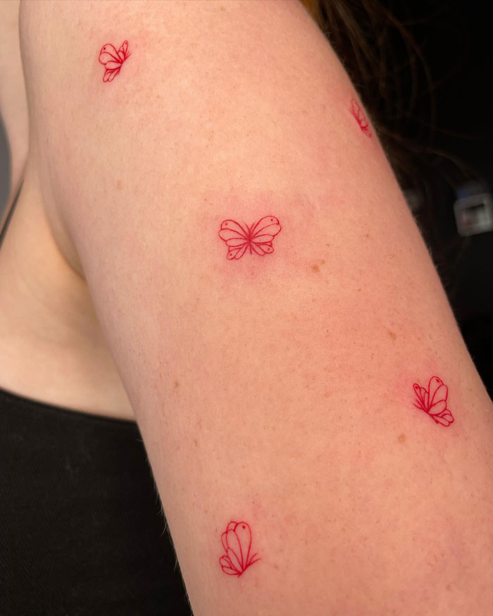 Minimalistic red butterflies tattoo