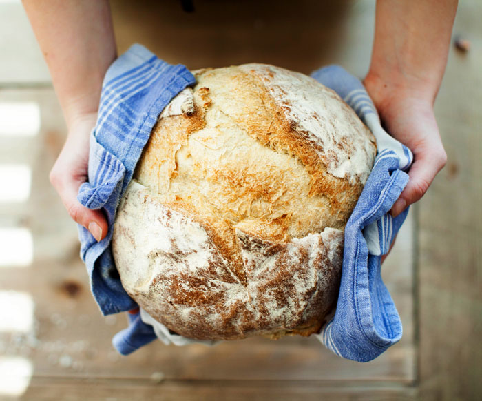 Person holding cooked bread