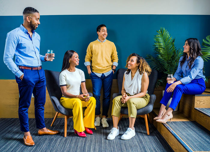 People wearing suits sitting standing and talking