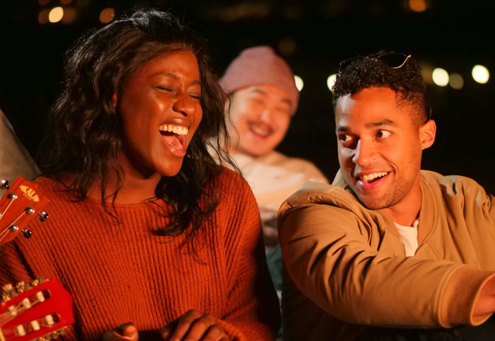 Woman singing and man watching