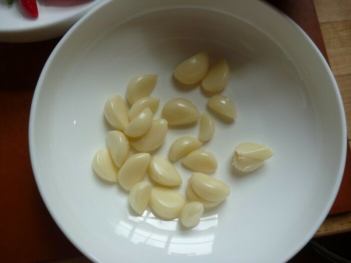 Peeling Garlic By Shaking It In A Container 