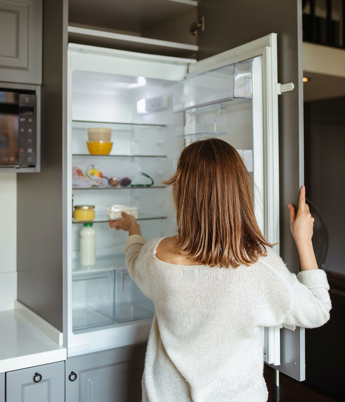 Woman taking food from freezer