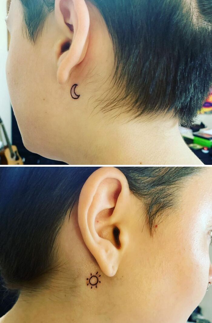 Minimalistic ear tattoos featuring a small crescent moon and sun design behind the ear.