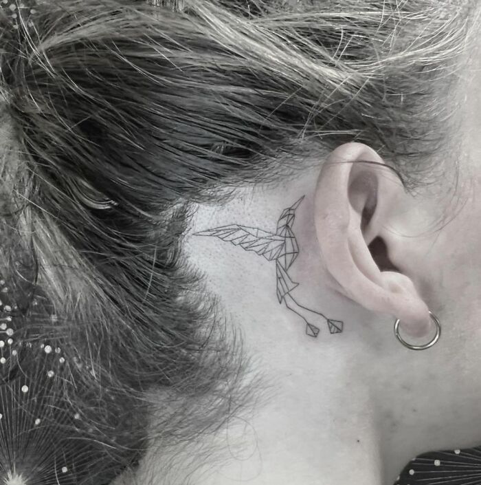 abstract ear tattoo of a bird