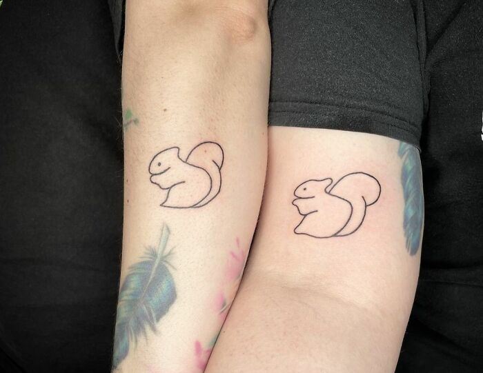 Minimalist squirrel best friend tattoos on forearms showcasing friendship art.