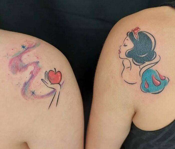 Two best friend tattoos: one of a hand holding an apple, the other of a princess with short dark hair and a red bow.