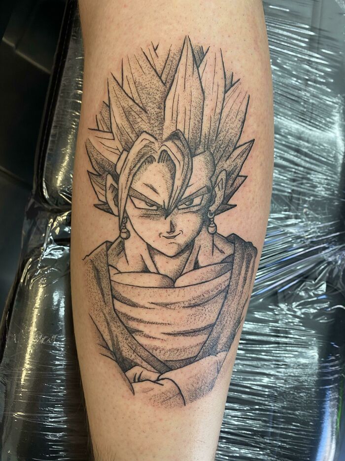 Anime character calf tattoo with intricate shading, showcasing a unique design.