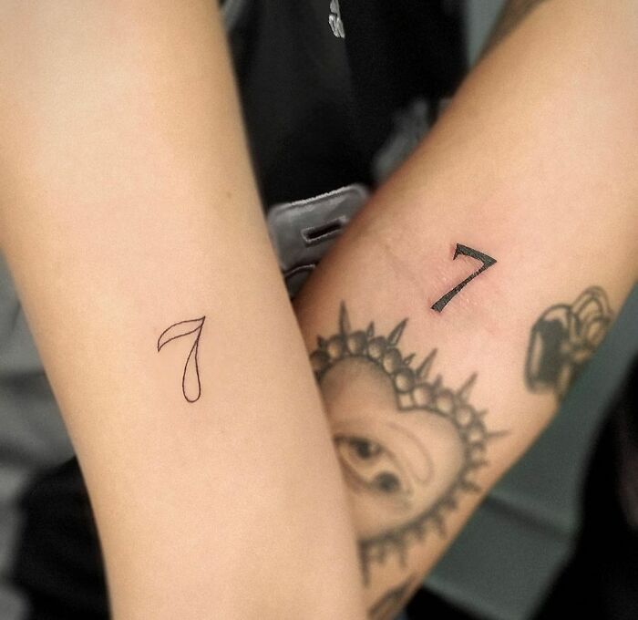Matching number 7 arm tattoos