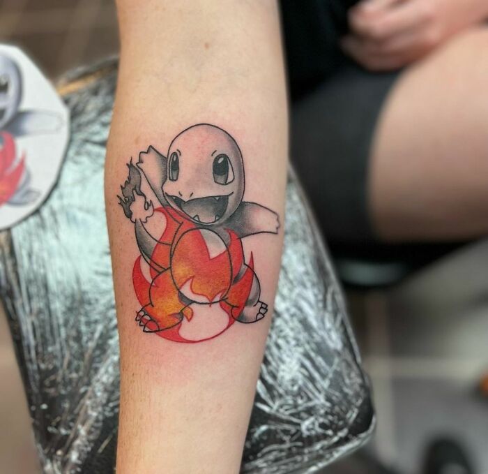 Pokémon character Charmander arm tattoo
