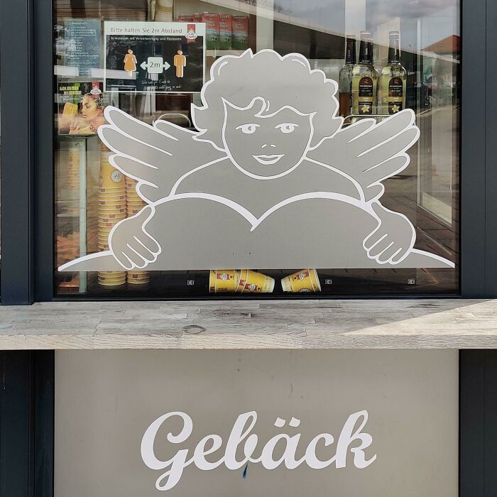 This Is The Logo Of A Local Bakery. Looks Like The Angel Is About To Eat Some A**