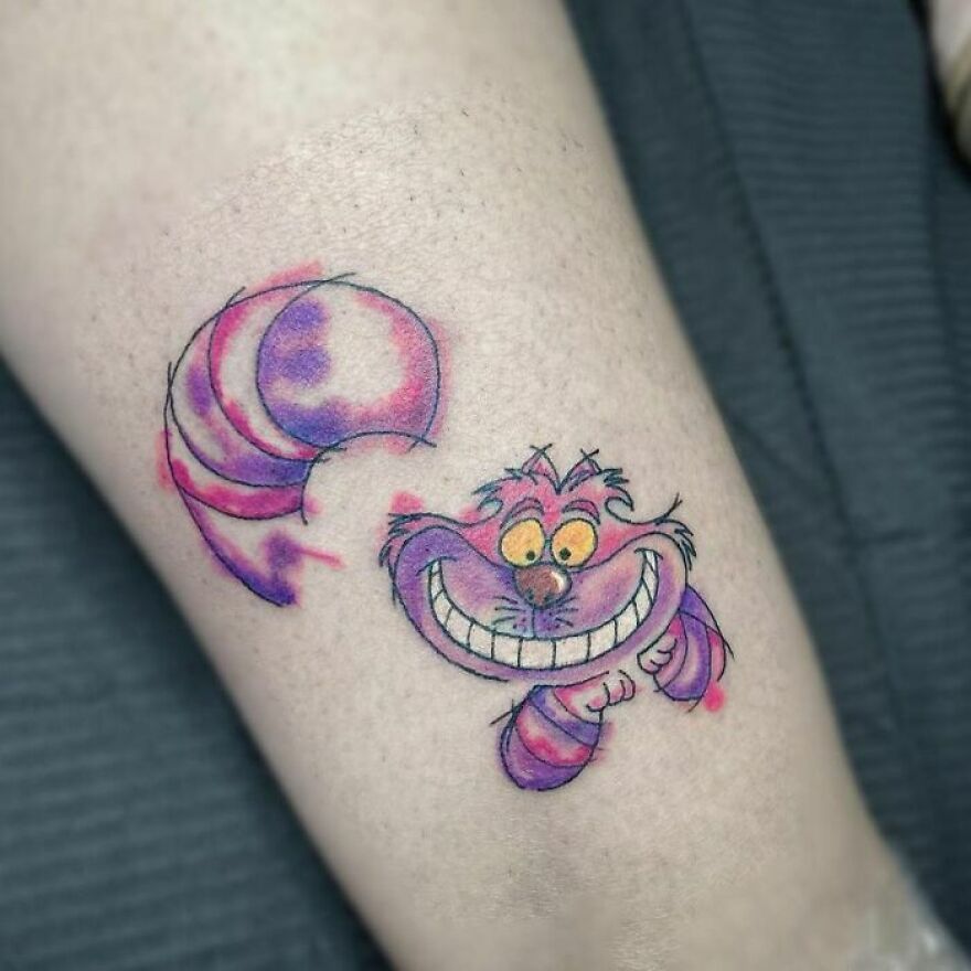 Watercolor cheshire cat tattoo on the leg
