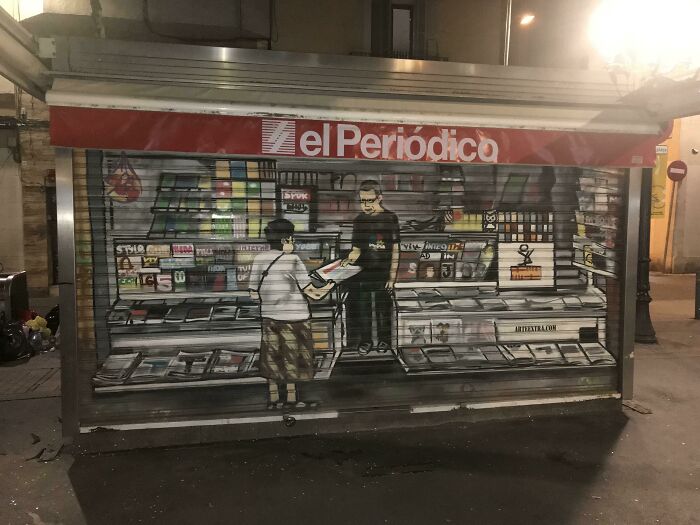 This Graffiti On A Closed Newspaper Stand Replicates When It Is Open In Barcelona