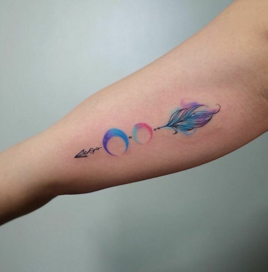 colorful arrow tattoo on the arm