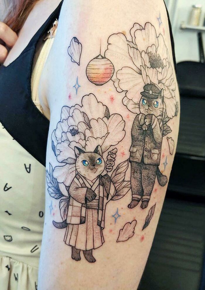Two cats with blues eyes and flowers tattoo
