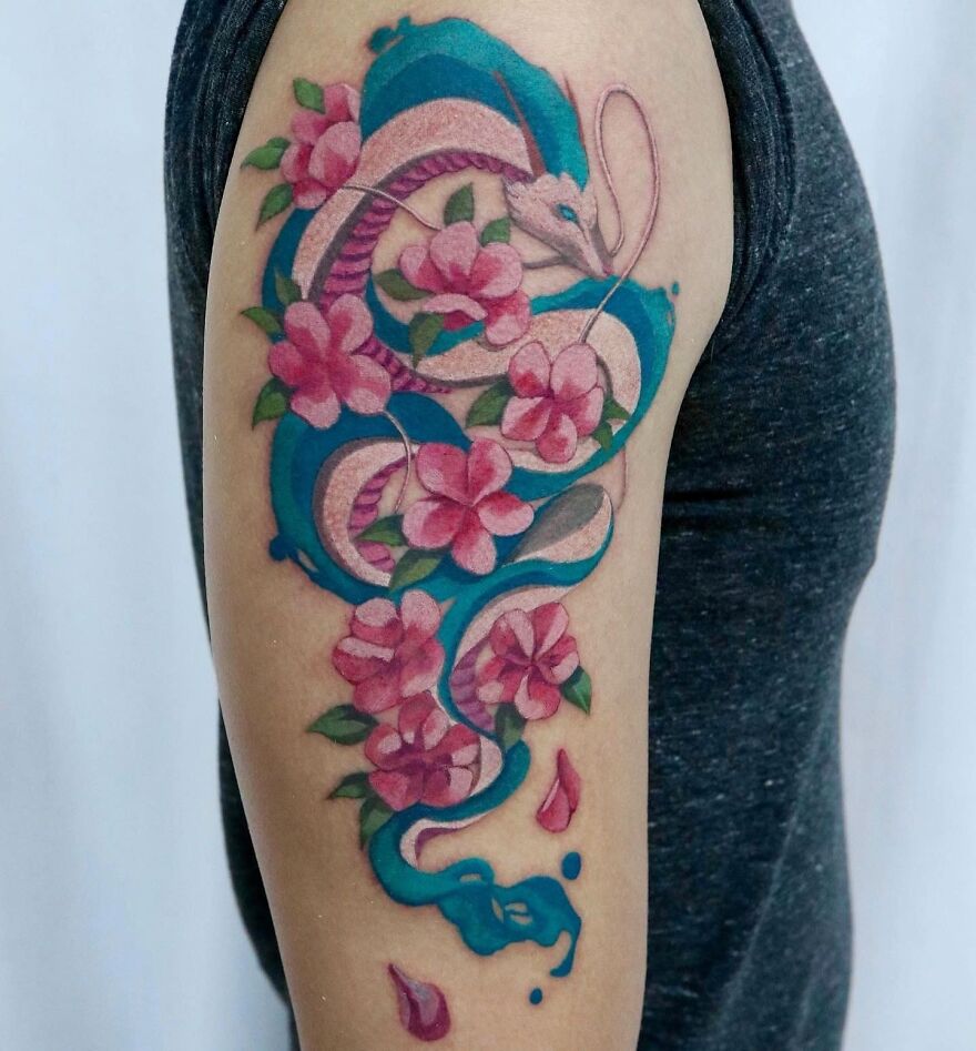 colorful snake and flowers tattoo on the arm