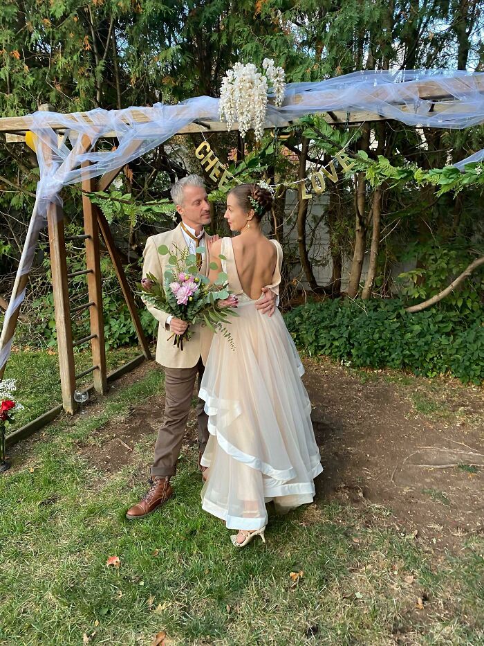 My New Husband And I Under Our Swingset- Turned Wedding Arch!