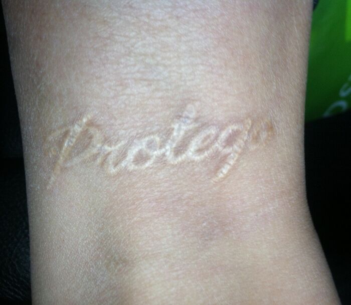 "Subtle Protego spell tattoo on wrist for Harry Potter fans."