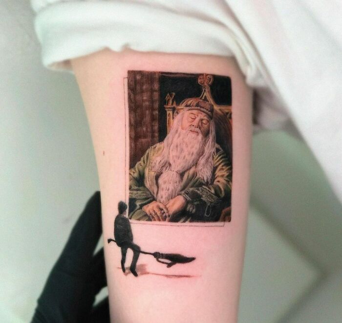 Harry Potter tattoo with a wizard on a broomstick and a portrait of an elderly bearded man with a crown-like headpiece.