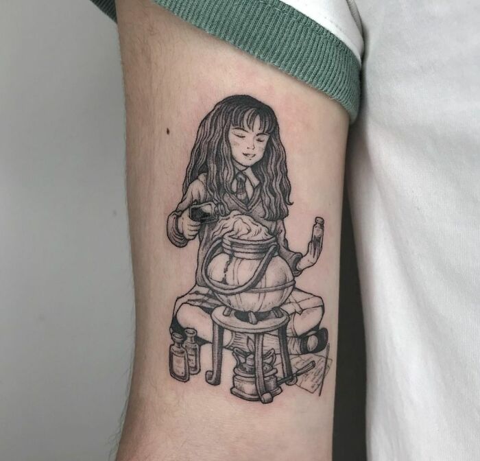 Harry Potter tattoo of a character brewing a potion, inked on arm.
