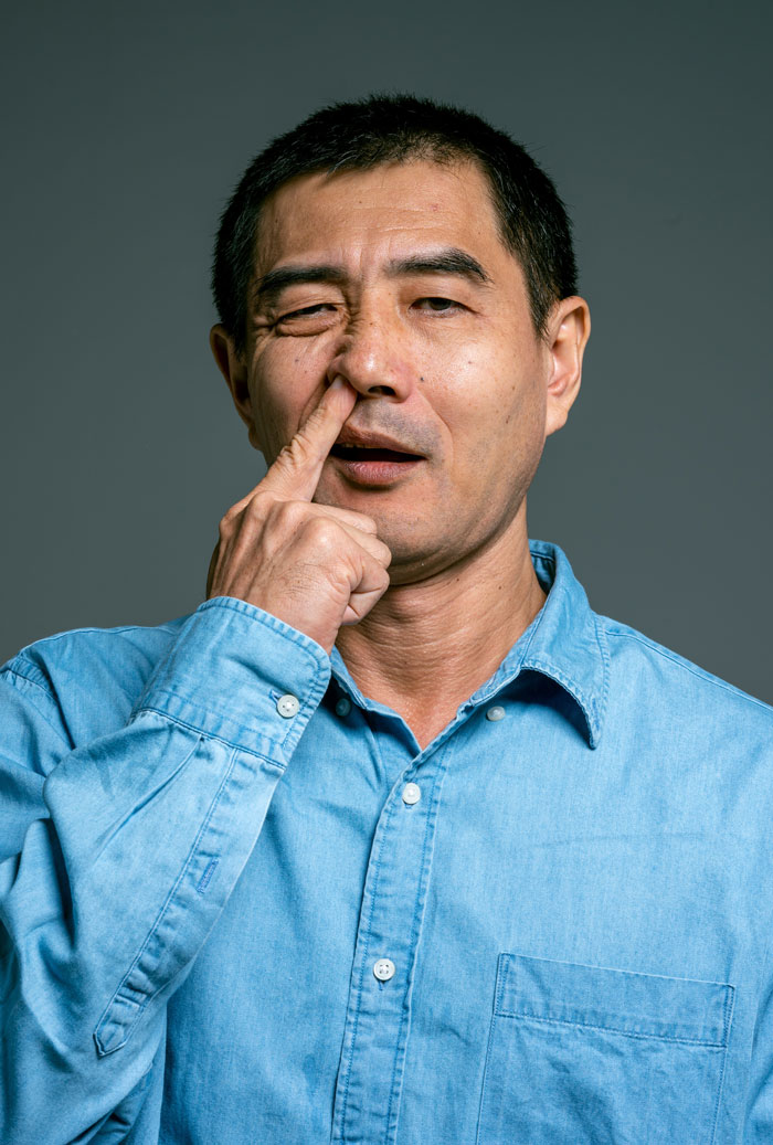 Man picking nose