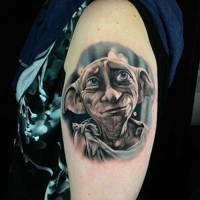 Tattoo of a house elf on an arm, showcasing a detailed portrait for fans of the Wizarding World.
