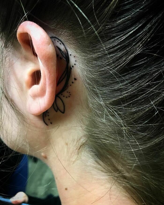 hidden ear tattoo of a line and dot pattern