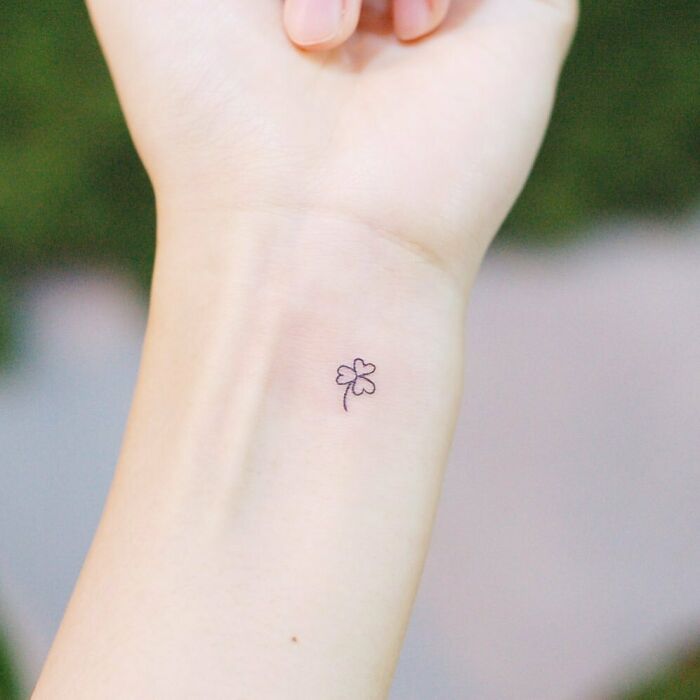 minimalistic tattoo of a three leaf clover