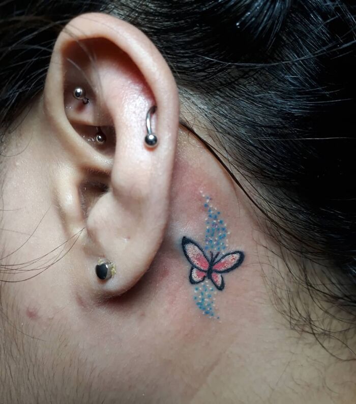 ear tattoo of a butterfly and blue mist