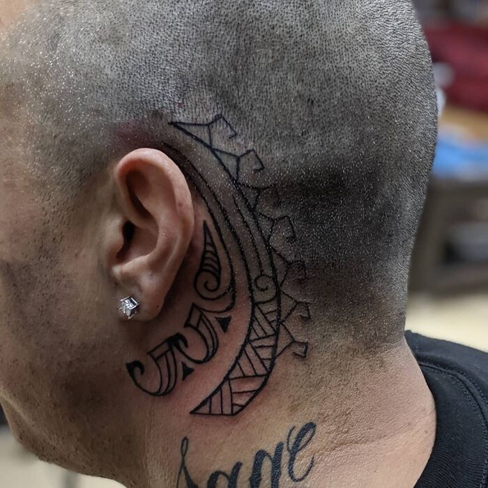 ear and temple tattoo of an ornamental design