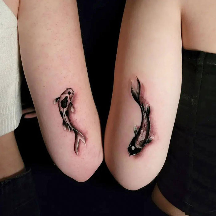 Matching koi fish best friend tattoos on forearms, symbolizing friendship and unity.