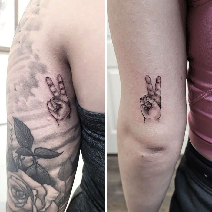 Matching little peace sign hands arm tattoos