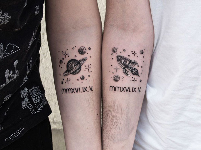 Matching planet and rocket tattoos