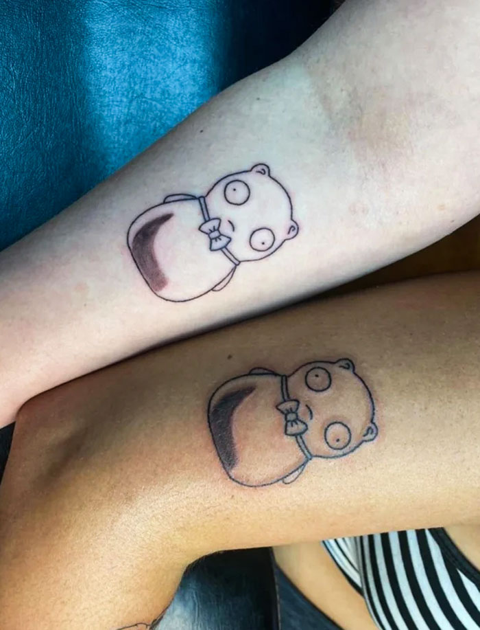 Matching best friend tattoos of cartoon characters on two arms.