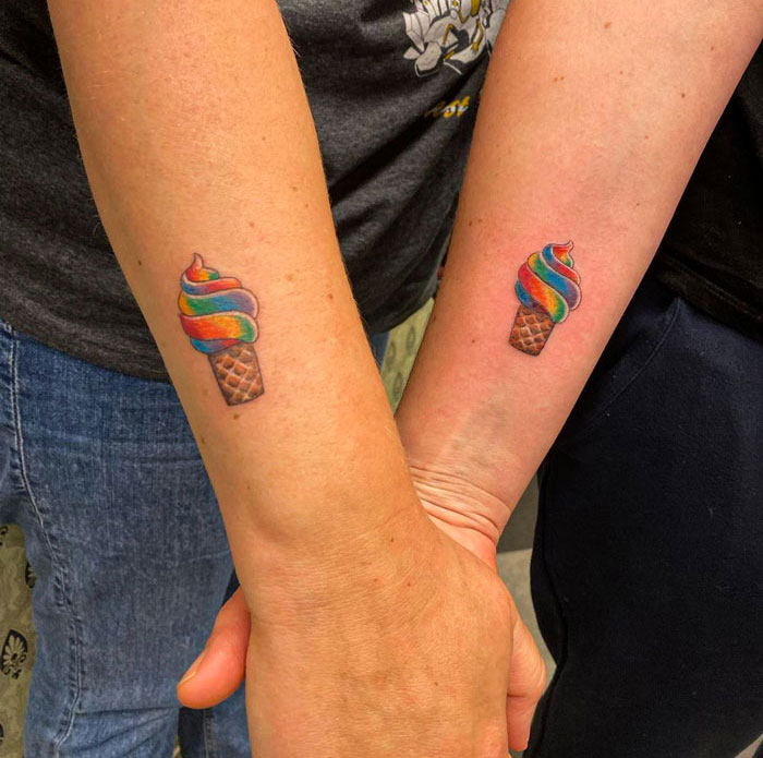 Colorful ice cream cone best friend tattoos on two forearms, symbolizing friendship.